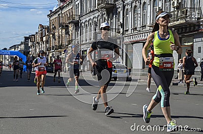 Group of runners racing at the city street during run competition in Kyiv Editorial Stock Photo