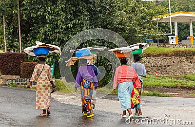 Group of Rwandan women in colorful traditionals clothes wearing washbowls on their heads, Kigali, Rwanda Editorial Stock Photo