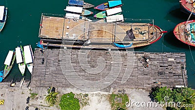 Group of sailing boats anchoring in marina next to jetty wooden pier. Aerial photo, high angle of view, bird eye Stock Photo