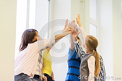 Group of school kids making high five gesture Stock Photo