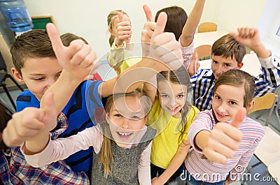 Group of school kids showing thumbs up Stock Photo