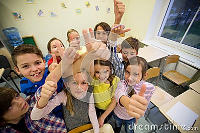 Group of school kids showing thumbs up Stock Photo