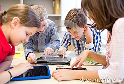 Group of school kids with tablet pc in classroom Stock Photo