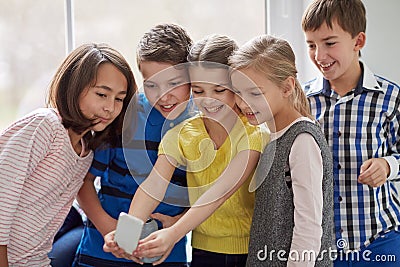 Group of school kids taking selfie with smartphone Stock Photo