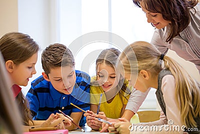 Group of school kids writing test in classroom Stock Photo