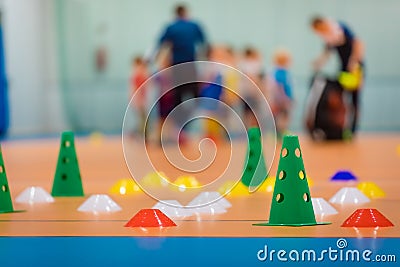 Group of school sports equipment on wooden floor. School children training soccer at indoor soccer field Stock Photo