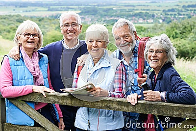 Group Of Senior Friends Hiking In Countryside Stock Photo