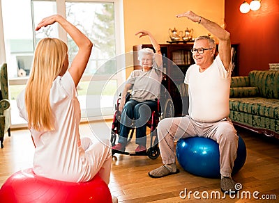 Group of senior people exercise with physiotherapist in private Stock Photo