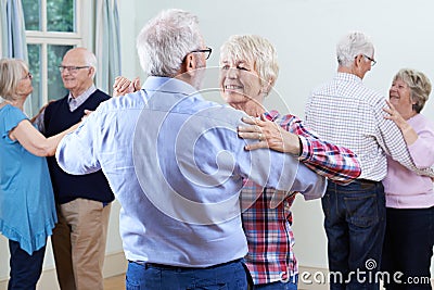 Group Of Seniors Enjoying Dancing Club Together Stock Photo