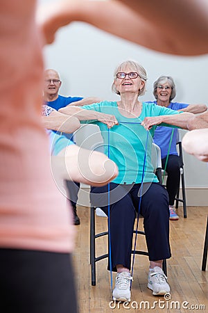 Group Of Seniors Using Resistance Bands In Fitness Class Stock Photo