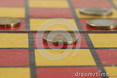 A group of several EUR coins is on the chessboard Stock Photo