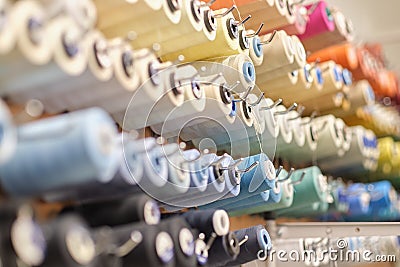 group of sewing threads in skeins. A bunch of large multicolored spools of thread. Atelier workshop. A set of colored Stock Photo