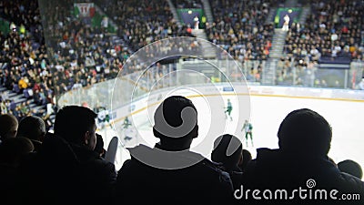 A group of silhouettes of young people watching hockey match in a closed stadium Editorial Stock Photo