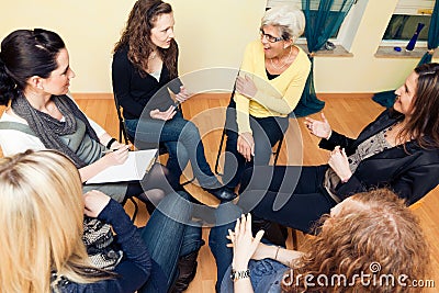 Group Of Women Sitting In A Circle, Discussing Stock Photo