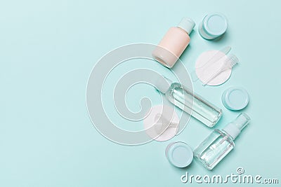 Group of small bottles for travelling on blue background. Copy space for your ideas. Flat lay composition of cosmetic products. Stock Photo