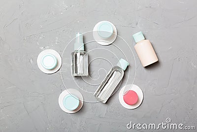 Group of small bottles for travelling on gray background. Copy space for your ideas. Flat lay composition of cosmetic products. Stock Photo