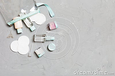 Group of small bottles for travelling on gray background. Copy space for your ideas. Flat lay composition of cosmetic products. Stock Photo