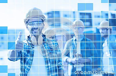 Group of smiling builders in hardhats outdoors Stock Photo