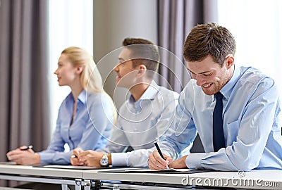 Group of smiling businesspeople meeting in office Stock Photo