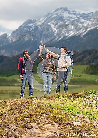 Group of smiling friends with backpacks hiking Stock Photo