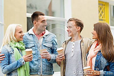 Group of smiling friends with take away coffee Stock Photo