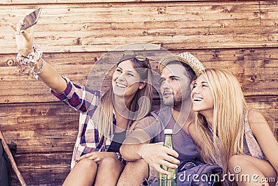 Group of smiling friends taking funny selfie Stock Photo