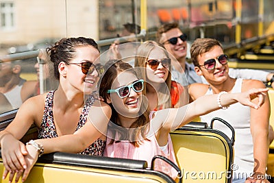 Group of smiling friends traveling by tour bus Stock Photo