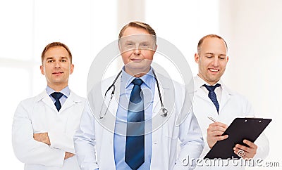 Group of smiling male doctors in white coats Stock Photo