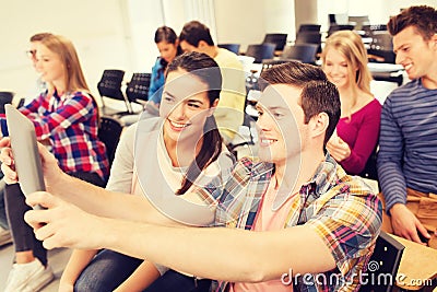 Group of smiling students with tablet pc Stock Photo