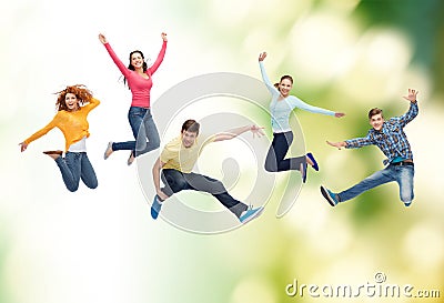 Group of smiling teenagers jumping in air Stock Photo