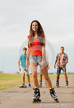 Group of smiling teenagers with roller-skates Stock Photo