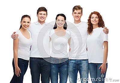 Group of smiling teenagers in white blank t-shirts Stock Photo