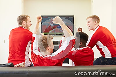 Group Of Sports Fans Watching Game On TV At Home Editorial Stock Photo