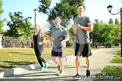 Group of sporty people running in park Stock Photo