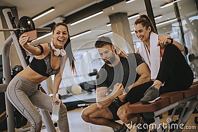 Group of sporty people in sportswear taking selfie photo with mobile phone at gym Stock Photo