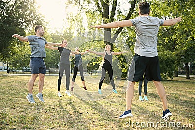 Group of sporty people training in park Stock Photo