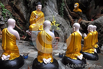 Sitting Buddha surrounded by monk students statues, Vietnam Stock Photo