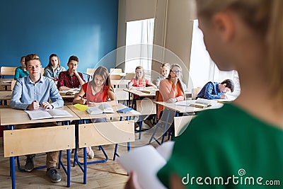 Group of students and girl with notebook at school Stock Photo