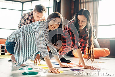 Group of students playing twister game Stock Photo