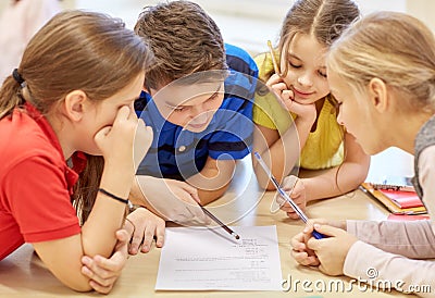 Group of students talking and writing at school Stock Photo