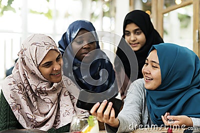 Group of students using mobile phone Stock Photo