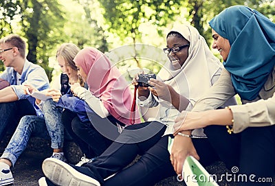 Group of students using mobile phone Stock Photo