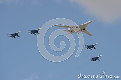 A group of SU-35S fighters and a Tu-160 supersonic long-range strategic bomber fly over Moscow`s Red Square during the dress rehea Stock Photo