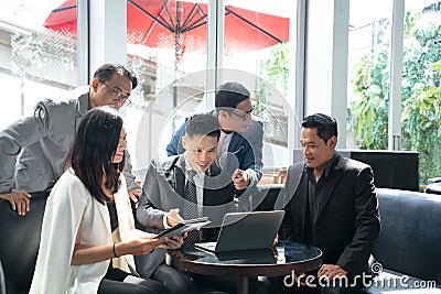 Group of successful business people cooperate discussing with his colleagues in coffee lounge Stock Photo