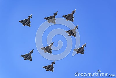 Group of supersonic planes in formation flying in the sky in a military parade. Editorial Stock Photo