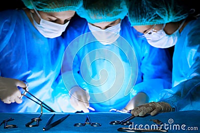 Group of surgeons in masks performing operation. Medicine, surgery and emergency help concepts Stock Photo