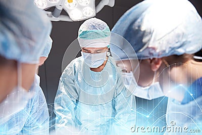 Group of surgeons in operating room at hospital Stock Photo