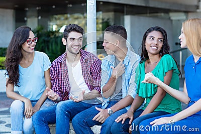 Group of talking young adult men and woman Stock Photo