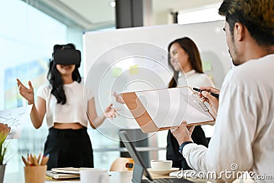 A group of tech developers brainstorming about their new virtual innovation project Stock Photo