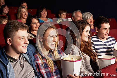 Group Of Teenage Friends Watching Film In Cinema Stock Photo